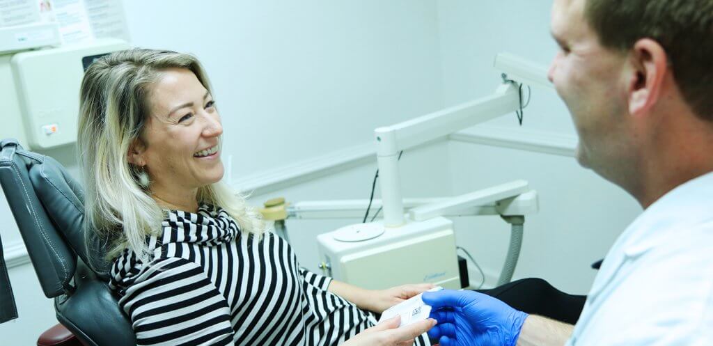 Dentist talking to patient