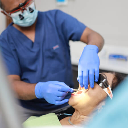 Strathfield dentist inspecting a patient's mouth