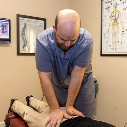 Adjusting patient's lower back