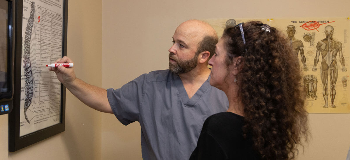 Dr Cole pointing to spine model