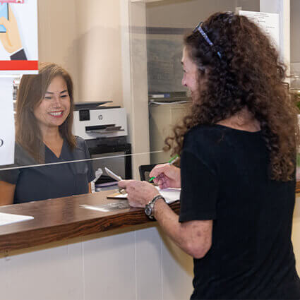 Patient at reception desk