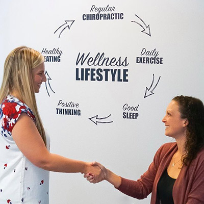 Dr Theresa shaking hands with patient