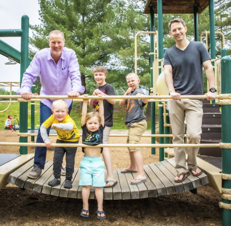 Dr. Scott with patients on jungle gym