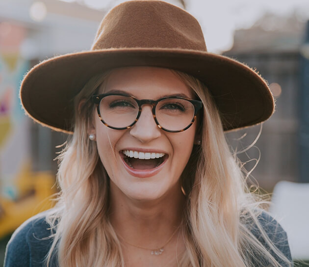 woman wearing a hat smiling