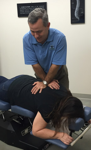 Dr. Permenter adjusting woman's back
