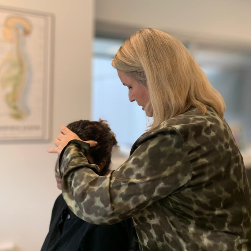 Genesis Chiropractic patient having neck adjusted