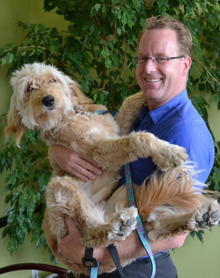 West Kelowna Chiropractor Dr. Kevin with therapy dog. 