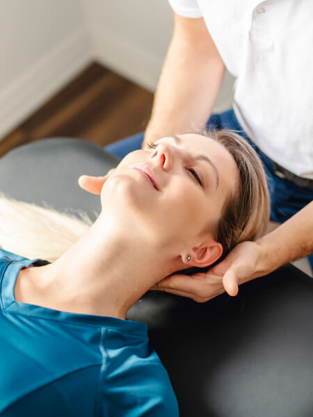 woman having neck adjusted