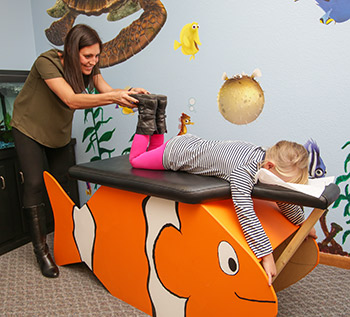 Dr. Stephanie Uthoff adjusting a child