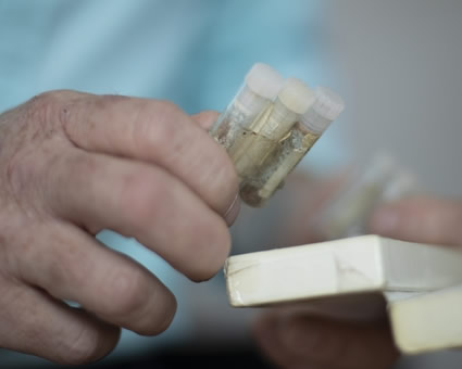 Dr Luke holding food testing bottles