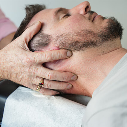 hands around man's head