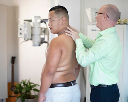 Dr Luke checking male patient for xray