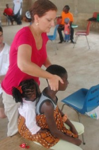 Dr. Schwab adjusting young girls in Africa.