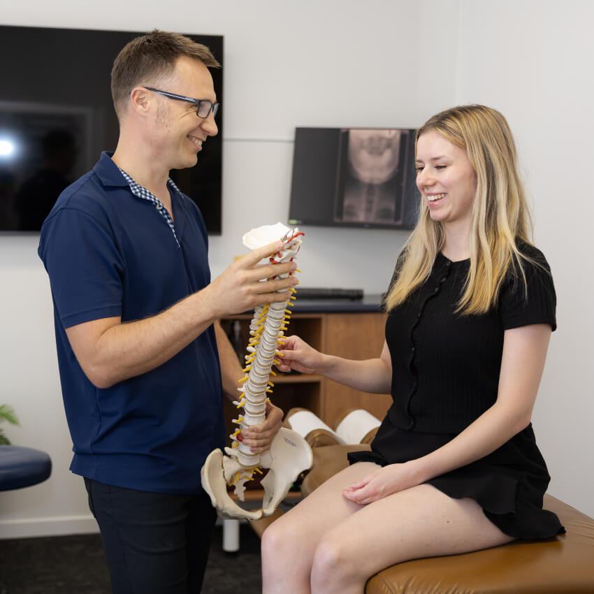 doctor holding spine model