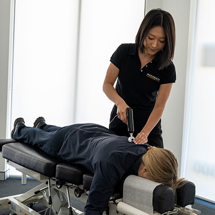 Dr Erin Cho adjusting a patient