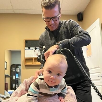 Baby having their neck adjusted