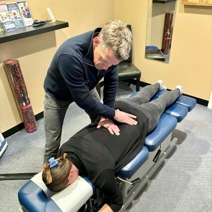 Dr Barry adjusting patients back