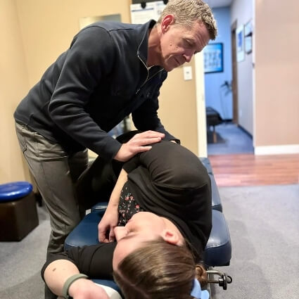 Dr Barry adjusting patients back