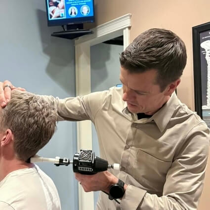 Dr Marka djusting patient using a tool