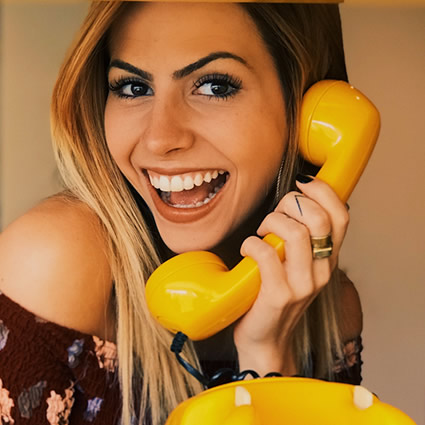 WOman on yellow telephone