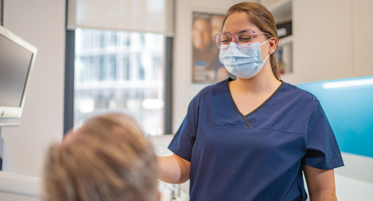 CDC Dental staff assisting patient