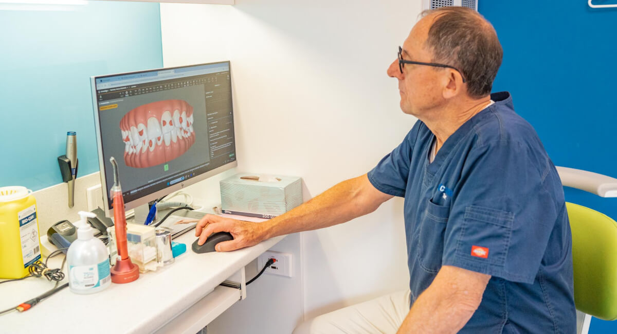 Sydney dentist studying scan results