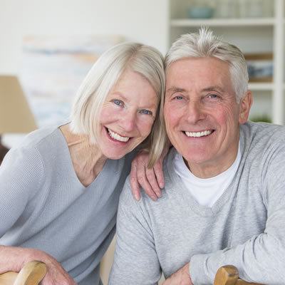 Old couple smiling perfect teeth