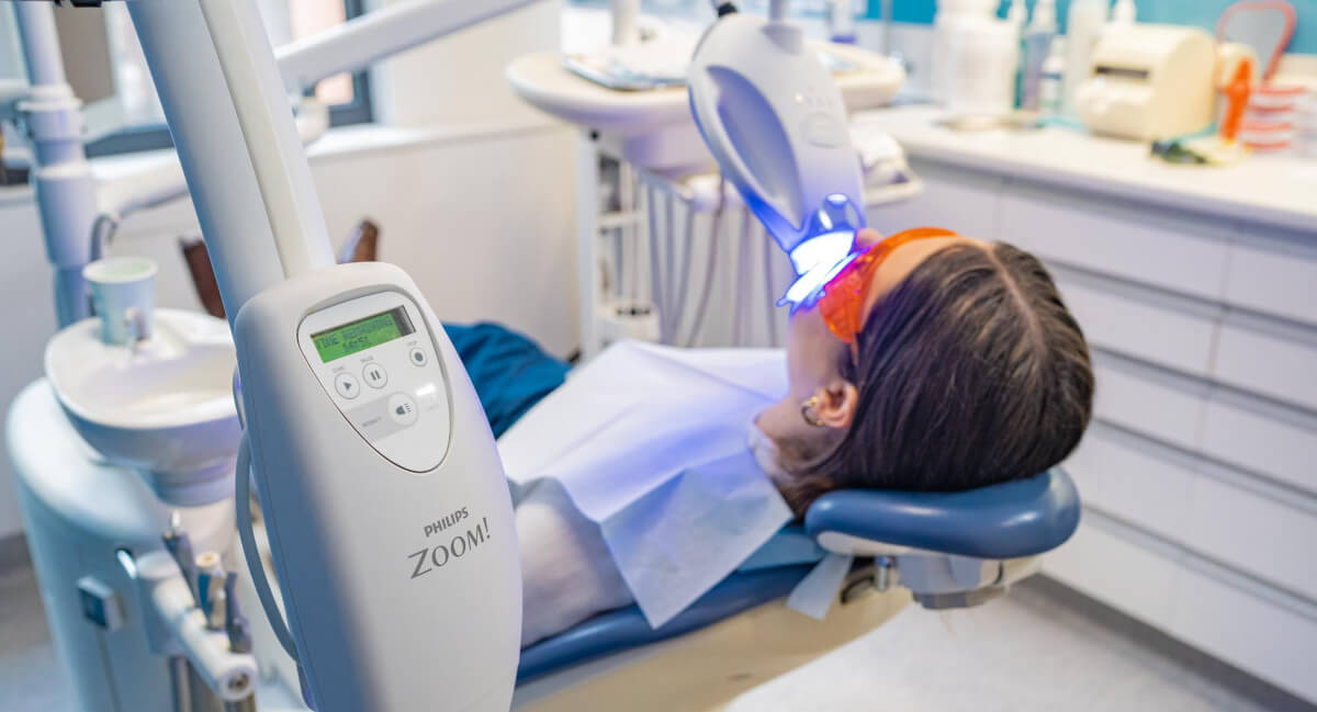 Female patient receiving teeth whitening treatment
