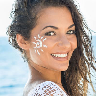 Woman on beach face painted