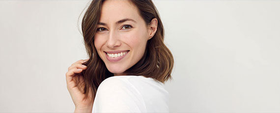 woman with short hair looking over shoulder