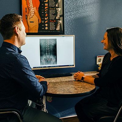 photo of chiropractor reviewing x-rays with a patient