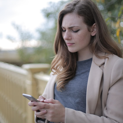 woman reading phone look stressed