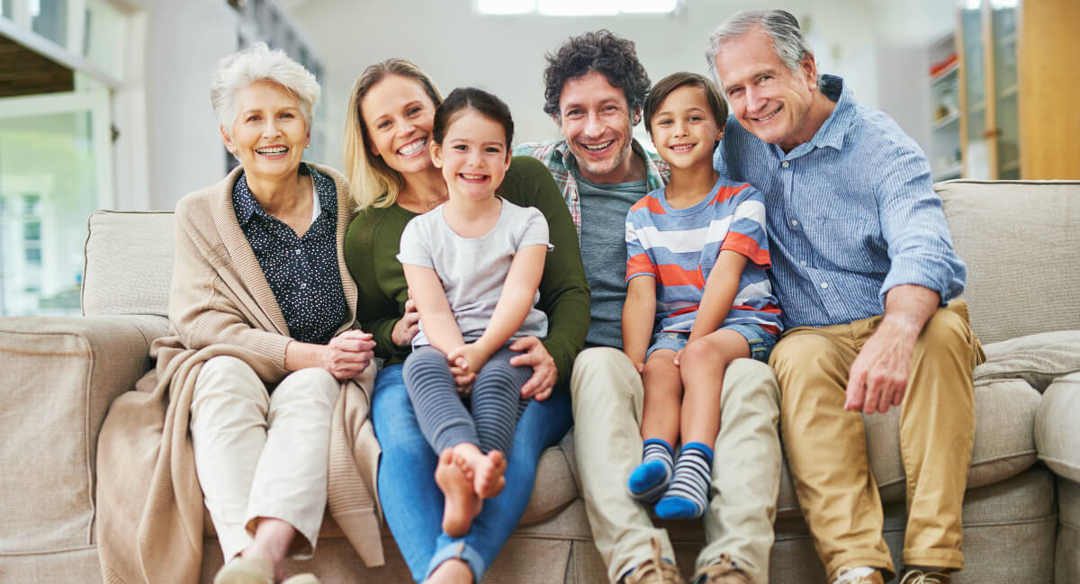 Multi-generational family sitting on a couch