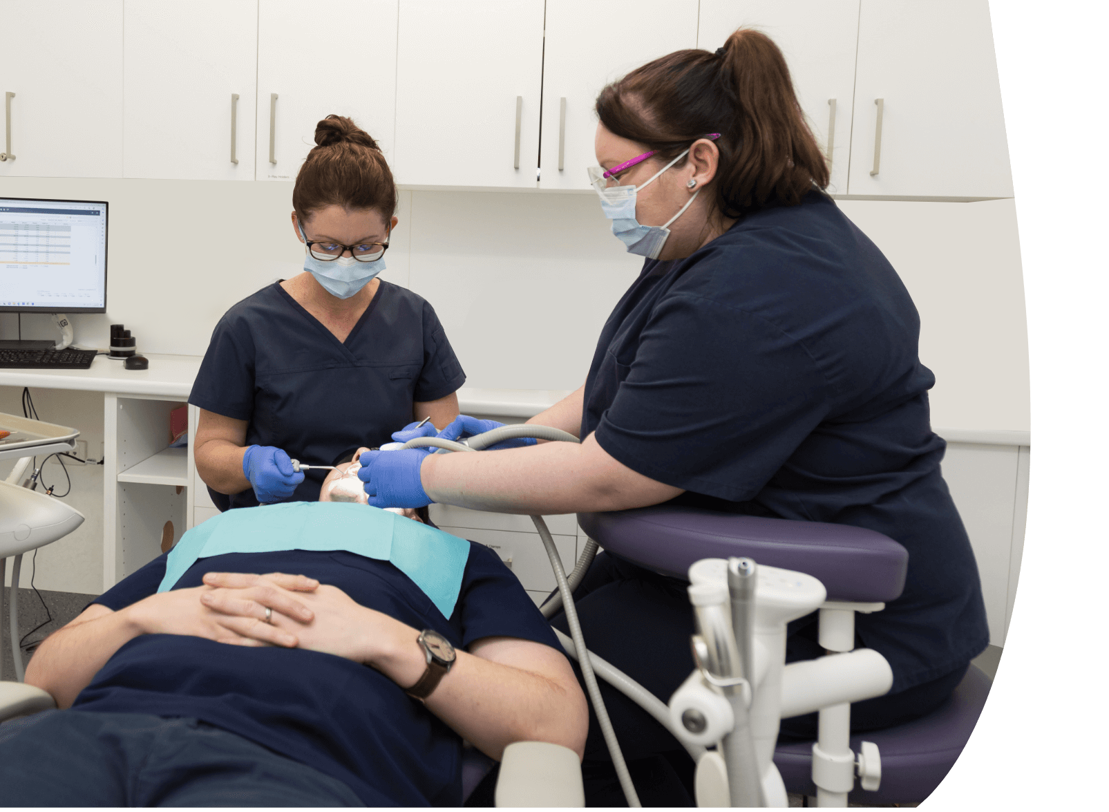 patient in dental chair getting cleaning