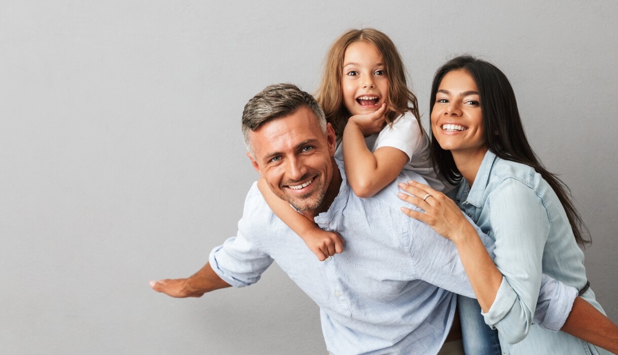 Smiling family of three
