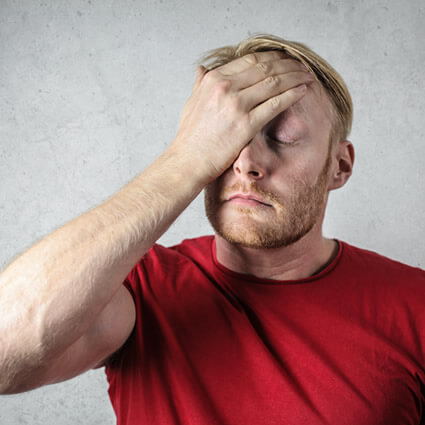 man red shirt with headache