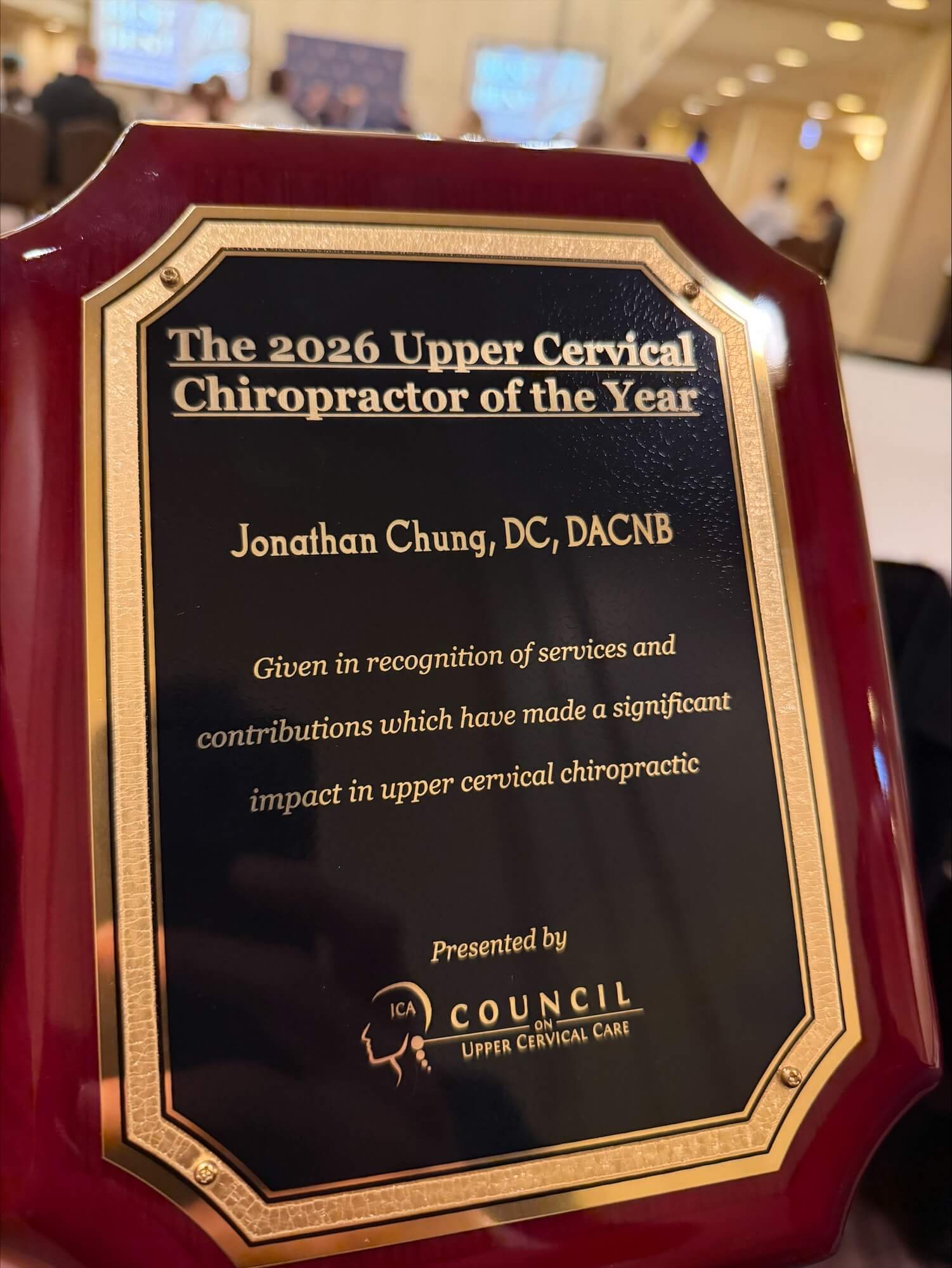 Dr. Jonathan Chung receiving the 2026 Upper Cervical Chiropractor of the Year award