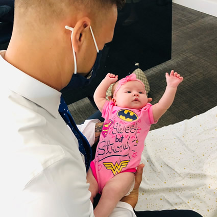 Dr Justin adjusting baby