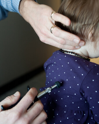 Steinbach chiropractor Dr. Trevor using activator method on pediatric patient