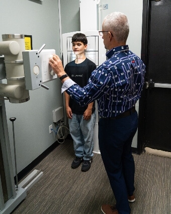 Steinbach chiropractor Dr. Trevor  setting up x-ray