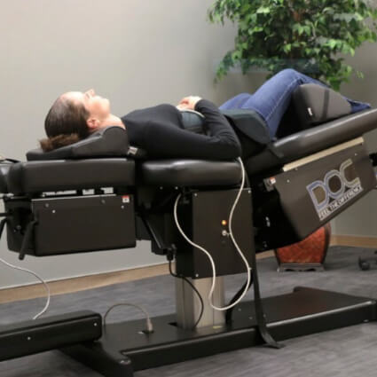All Seasons Chiropractic patient laying on spinal decompression table