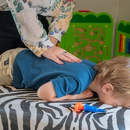 child having back adjusted