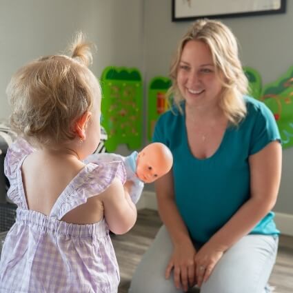 Mom and child playing together in our office