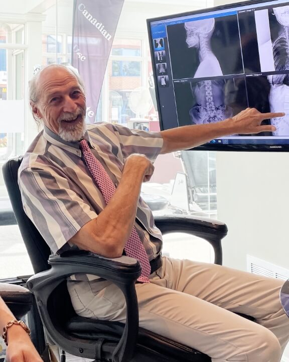 Aurora chiropractor pointing at X-ray