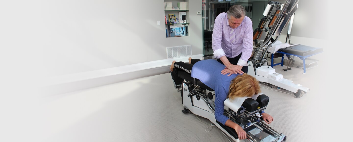 Aurora Chiropractor Dr. Brian Moore adjusting a patient