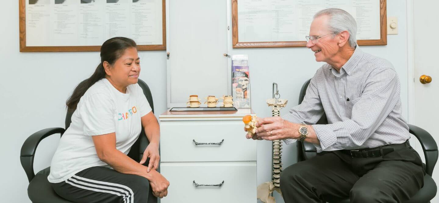 Anaheim chiropractor Dr. Majer educating a female patient