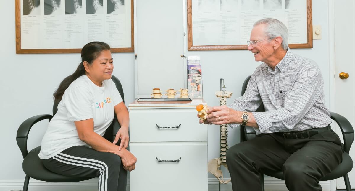 Anaheim chiropractor Dr. Gerald Majer in consultation with female patient