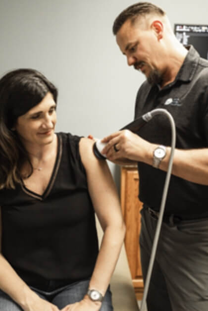patient with therapy tool on their arm