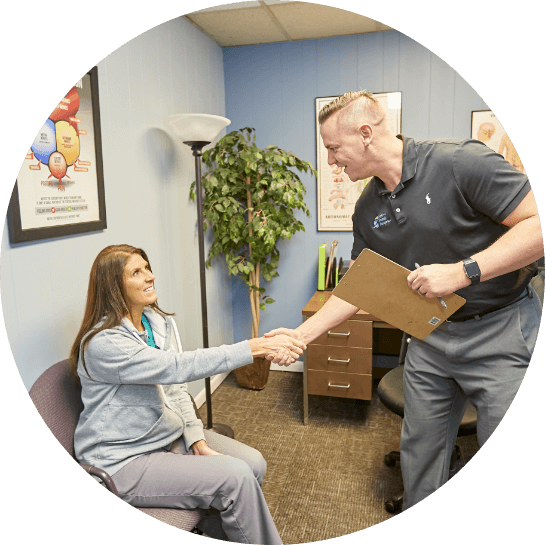 Chiropractor shaking hands with patient