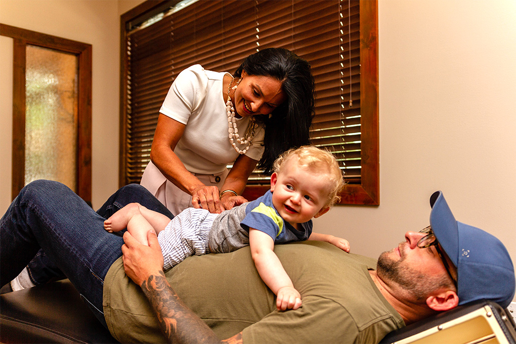 Doctor adjusting baby on parent's stomach